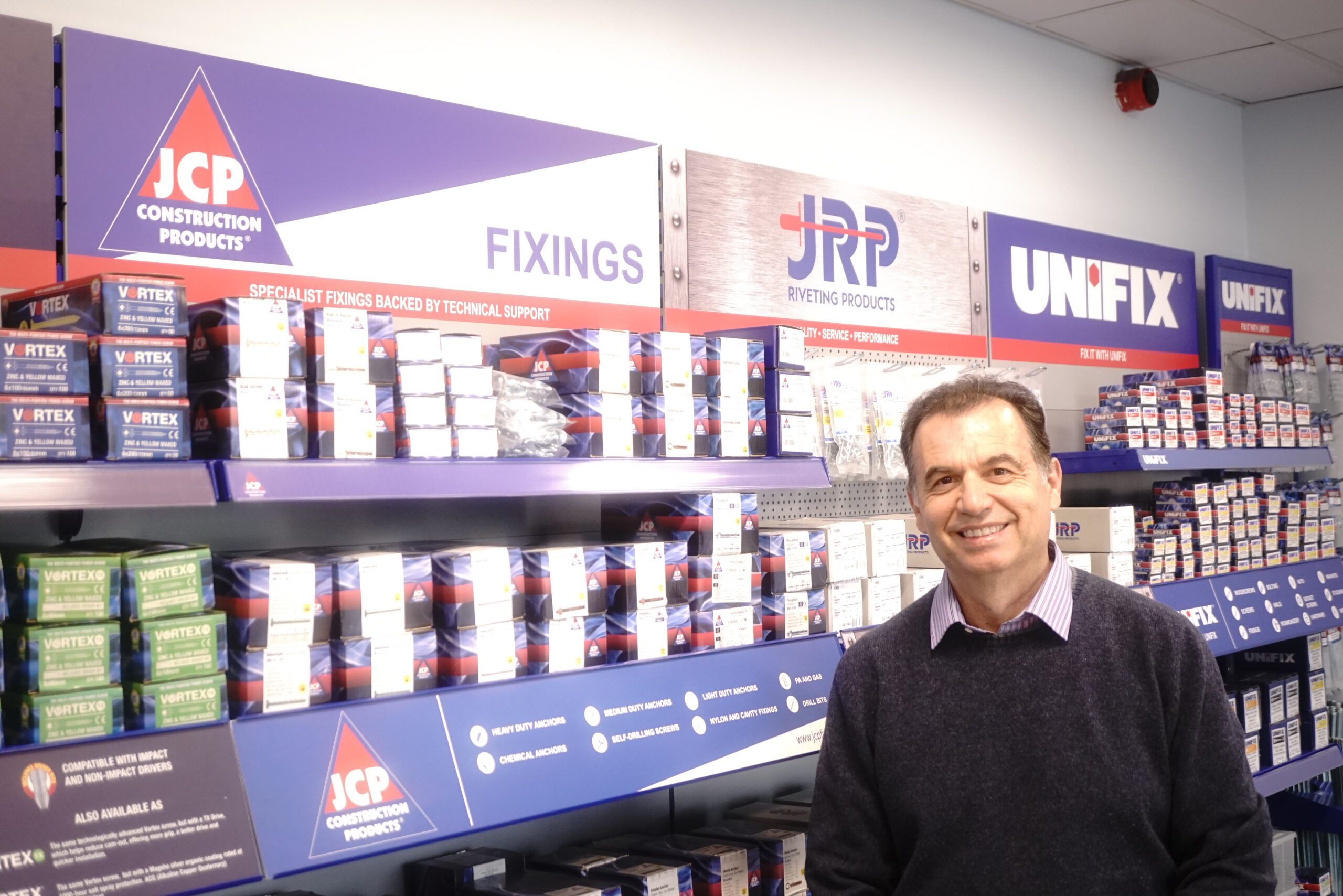 Vyron in front of JCP merchandising stand of products